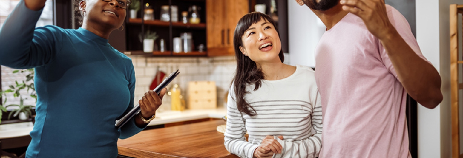 African American real estate agent showing house to multiracial couple | Gotcha Covered