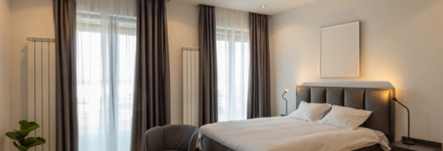 Interior of a bedroom with a large master bed | Gotcha Covered