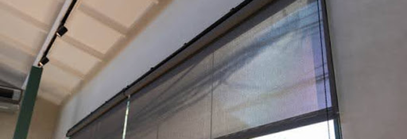 A window with a black exterior window screen that is open to the outside. | Gotcha Covered