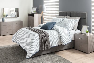 Dual zebra shades in a contemporary gray bedroom, offering adjustable light filtering and privacy